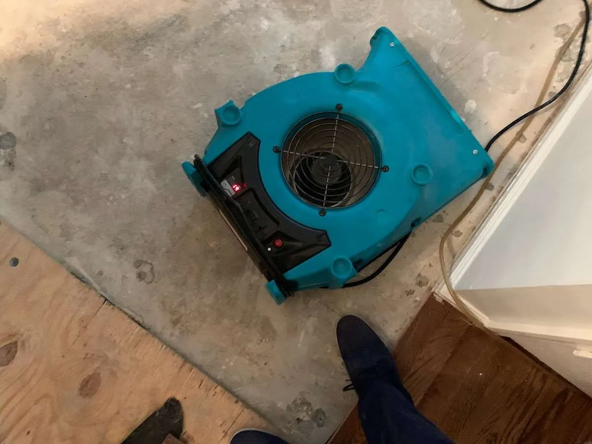 Air mover drying subfloor during Leak Detection & Repair in South Lebanon